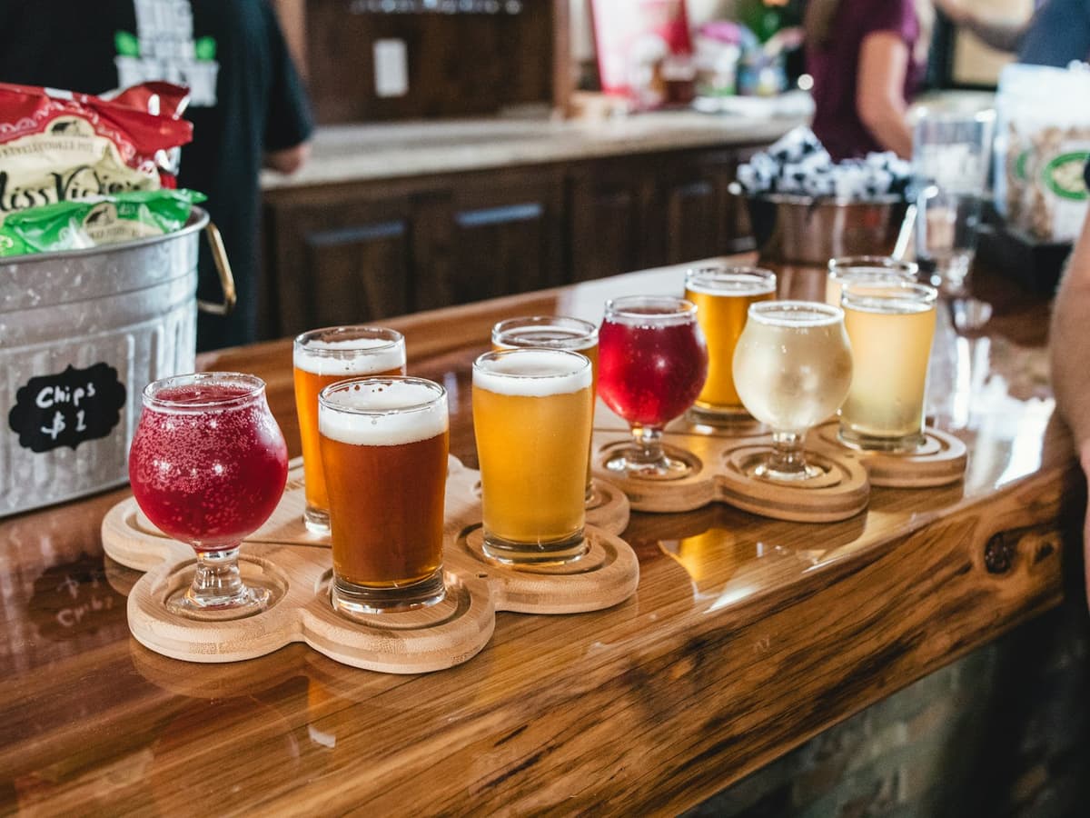 A tasting flight of beer and wine on a taproom bar